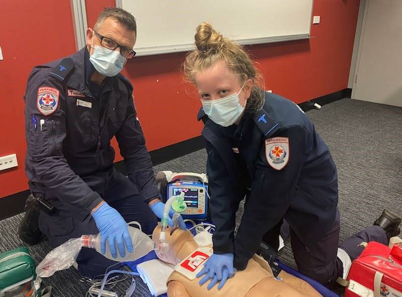 LIFE-SAVING: Graduate ambulance paramedics Jamie VanBruggen and Tash Middlin practice CPR at the Warrnambool ambulance station. Photo: Ambulance Victoria.