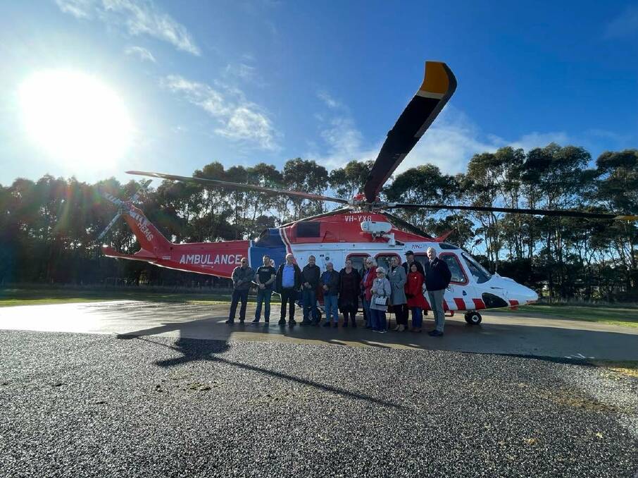 TEAMWORK: Corangamite Shire councillors and the Cobden Aerodrome Asset Committee stand in front of the HEMS 4. 