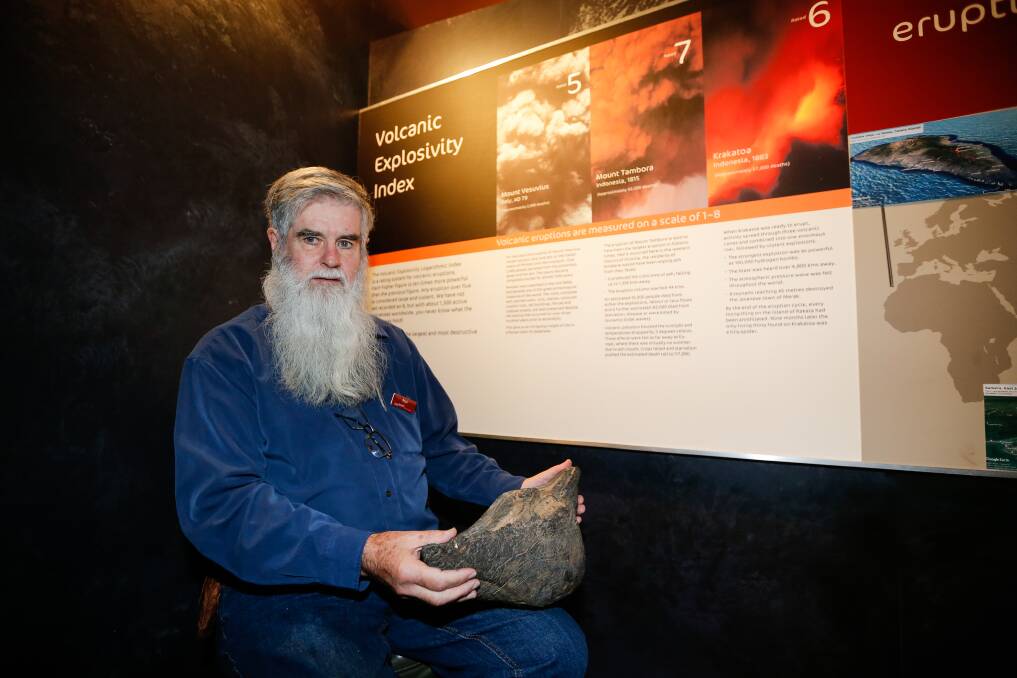 Paul Callander with a volcanic bomb. Picture: Anthony Brady