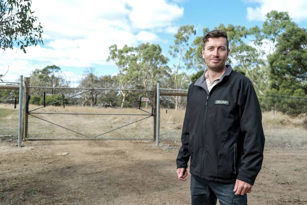 SAFE: Department of Environment, Land, Water and Planning natural environment program officer Jonathan Lee at the new predator-proof fence being installed at Hamilton Sanctuary. Picture: Chris Doheny
