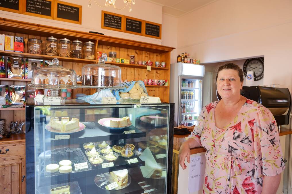 Julie, pictured with a selection of cakes and treats she's made. A variety of teapots, teacups and other small goods are also for sale. 