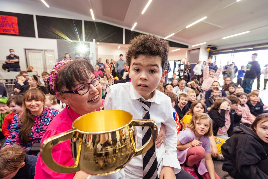 Merri River School education support worker Sharron Lowther and Joseph Van Kempen hold the iconic Melbourne Cup. Pictures by Sean McKenna.