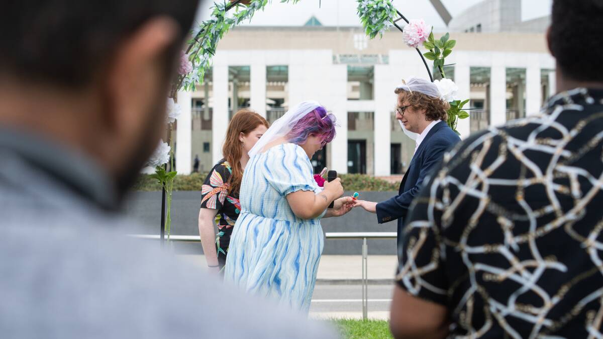 National Union of Students member Ebony Martinesz places a lolly ring on the finger of Max Marlans during a fake "marriage for Centrelink". Picture by Elesa Kurtz