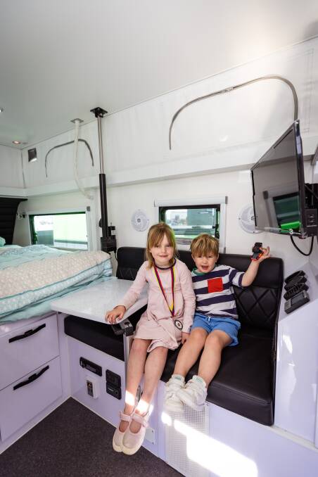 Pippa and Fergus Outhwaite sitting inside one of the caravans on display at the Warrnambool Caravan, Camping and Leisure Roadshow. Picture by Sean McKenna