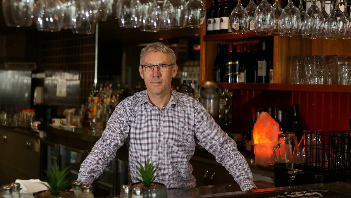 Images Restaurant owner and manager Jonathan Dodwell behind the bar says another public holiday is an extra cost for everyone. File picture