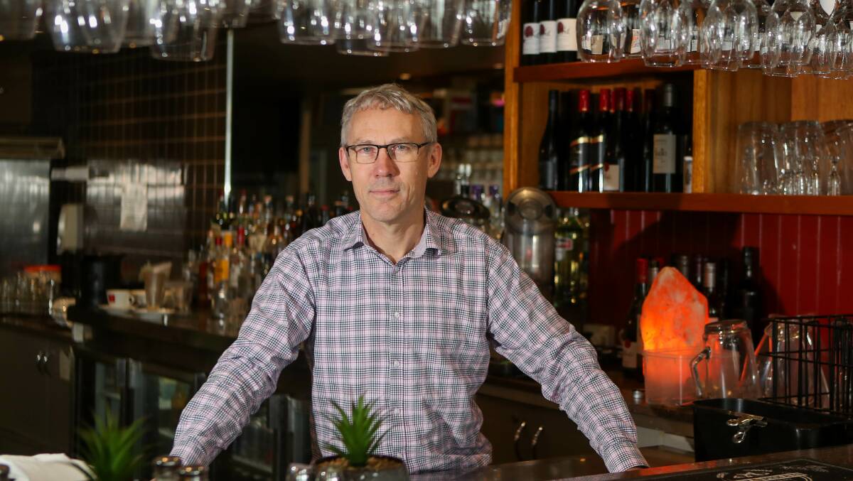 Warrnambool's Images Restaurant owner and manager Jonathan Dodwell stands at the venue's bar. 