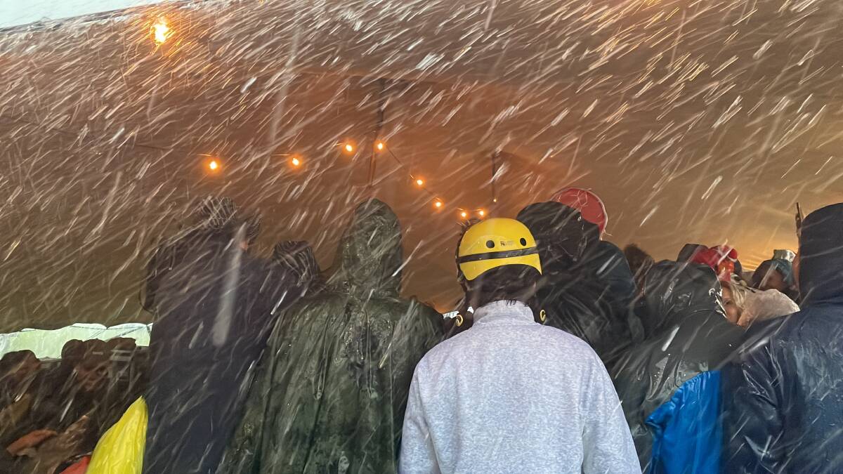 Rain pouring down as festivalgoers at Loch Hart Music Festival where attendees huddled under a tent to watch some of Australia's finest comedians take to the stage. Picture by Lillian Altman