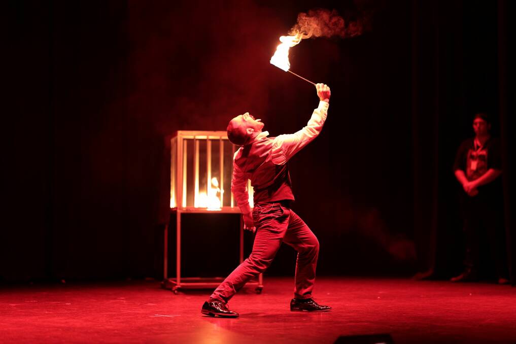 Luke Blaze fire eating on stage during a performance.