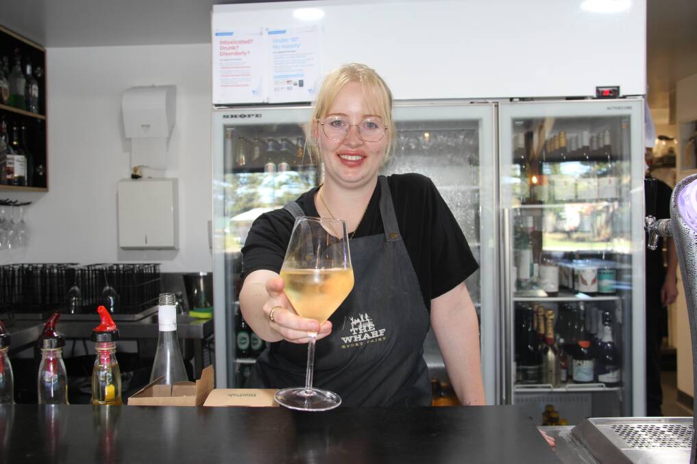 Pieta Roorda from the Netherlands holds a glass of wine at her workplace, The Wharf at Port Fairy. Picture by Lillian Altman