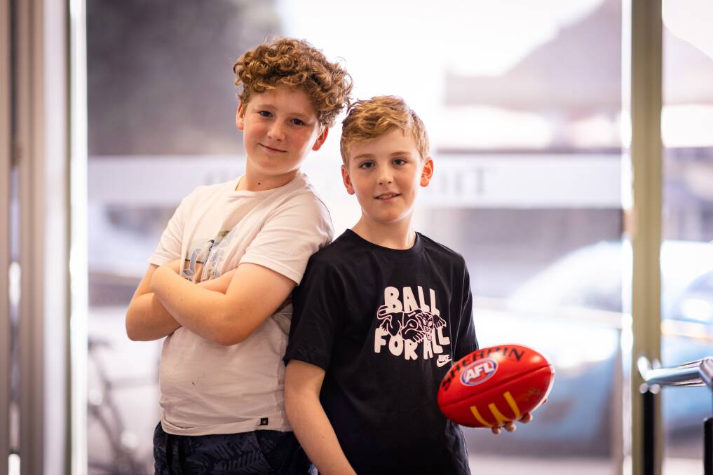 Billie, 12, and Archie, 10, McDonald have been reunited with Archie's signed AFLW Carlton football he lost in the sand at Warrnambool's foreshore on Tuesday evening, September 19. Picture by Sean McKenna
