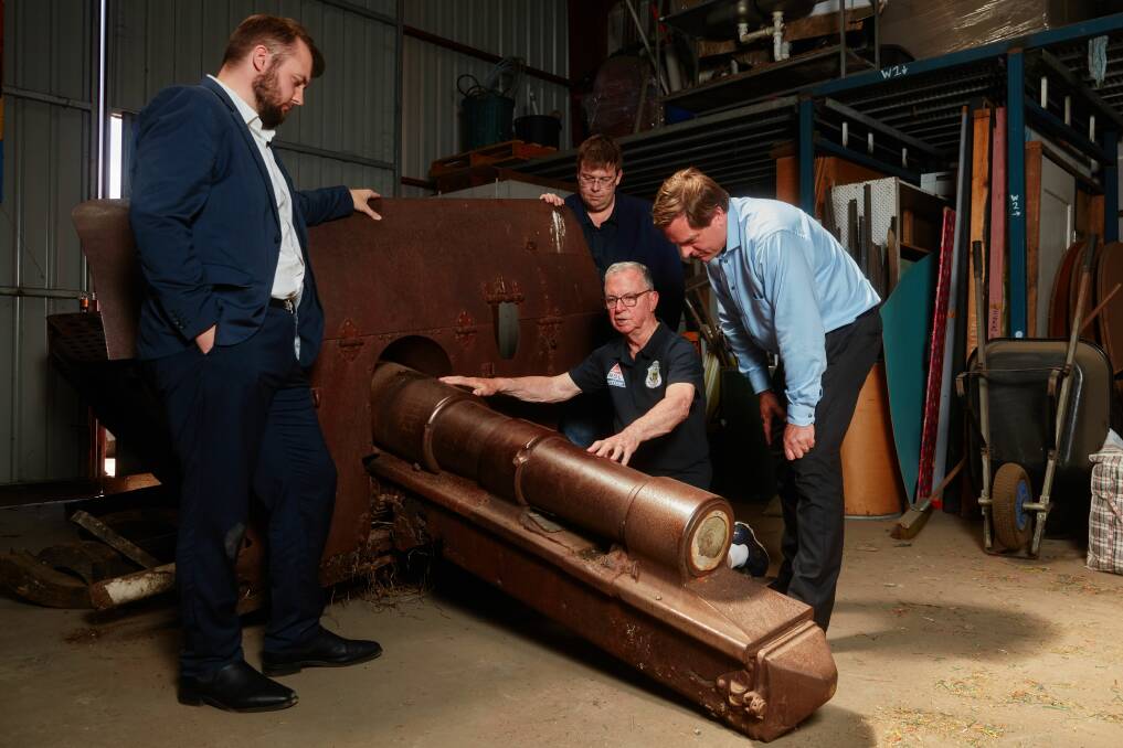 Warrnambool City Council governance manager James Plozza, mayor Ben Blain (back), war veteran Doug Heazlewood and WCC chief executive officer Andrew Mason with a war gun. Picture supplied by Warrnambool City Council