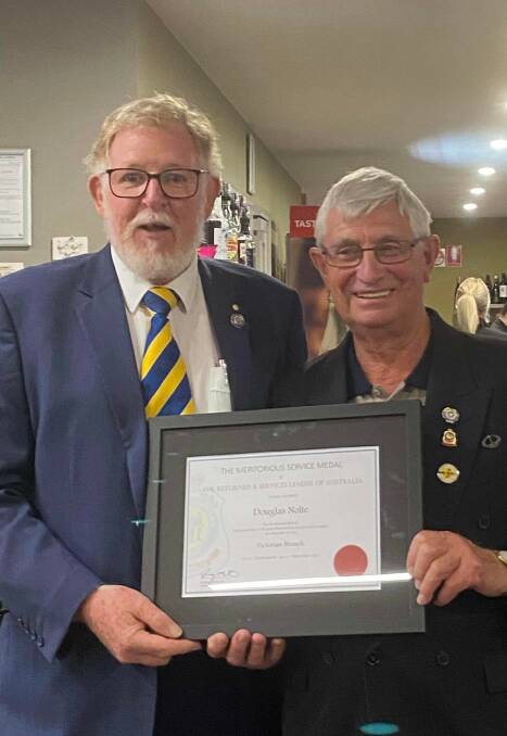 HIGHEST HONOUR: RSL Victoria state president Dr Rob Webster presenting Doug Nolte with a Meritorious Service Medal certificate.