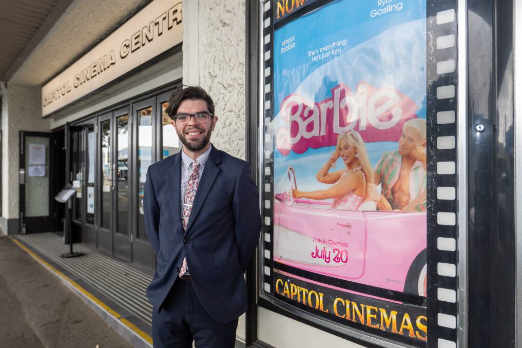 Warrnambool's Capitol Cinema general manager Daniel Tobin standing next to a Barbie film poster on the day of the film's release. Picture by Eddie Guerrero
