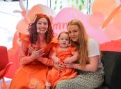 Emma Memma (Emma Watkins) at the Warrnambool Library and Learning Centre with Everly McCosh, 1, and Kelsey Williams. Picture by Anthony Brady