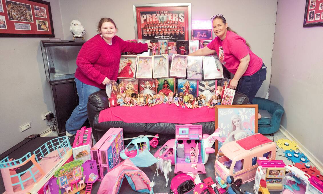 Warrnambool's Lillee-May, 11, and Billie-May Reason with their collection of 60 Barbies and merchandise. Picture by Sean McKenna