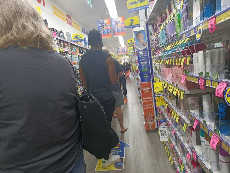 LINE UP: Customers queuing up at Chemist Warehouse Warrnambool Central this morning to purchase RATs which sold out in less than an hour. Picture: Lillian Altman