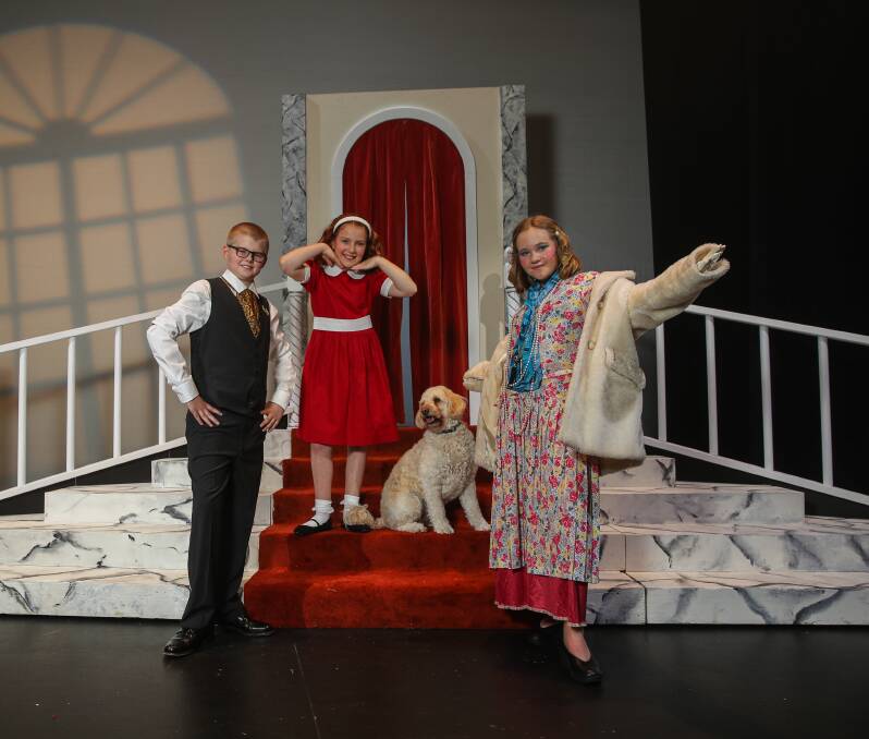 MUSICAL: Primary Performers cast members Finn Davis, 10, (playing Daddy Warbucks), Lily Cheeseman, 10, (Annie) and Cassie Hartwich, 11, (Miss Hannigan) at Lighthouse Theatre. Picture: Morgan Hancock