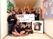 DONATION: Representatives from the 24-hour Shear-a-thon donated $23,000 to Merri River School on Friday. Picture: Chris Doheny