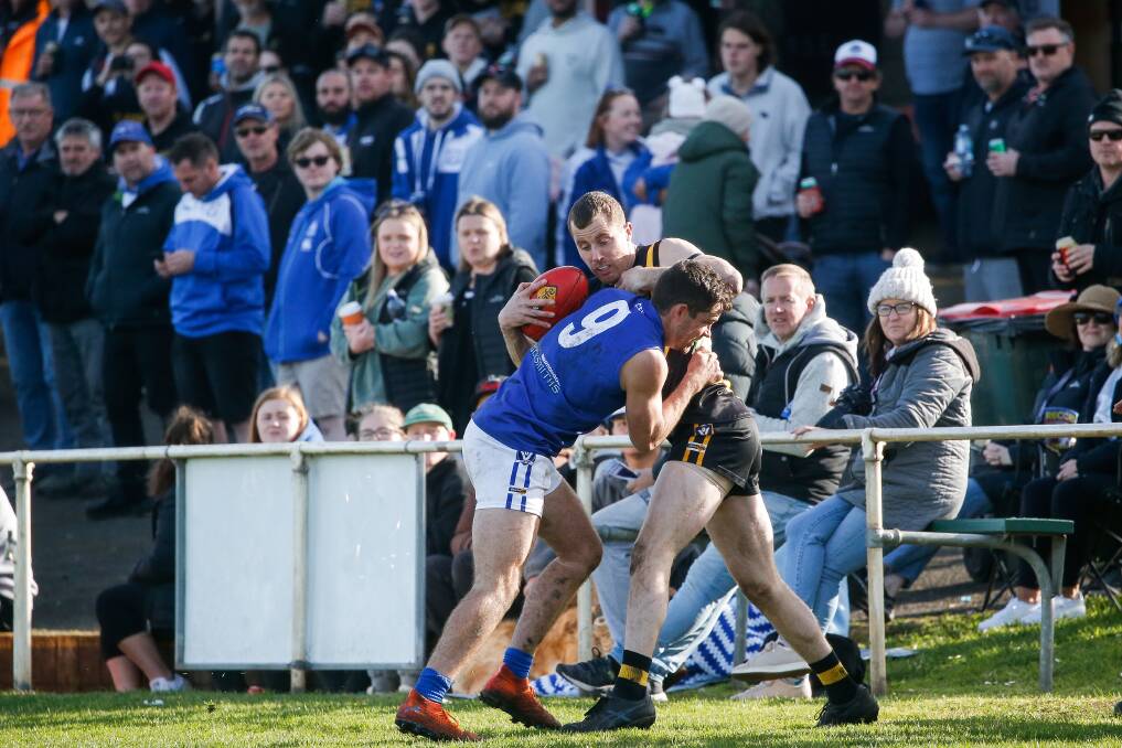 Russells Creek's Daniel Nicolson tackles Merrivale's Sean Barnes in front of a packed crowd in a Warrnambool and District league an elimination final. Picture by Anthony Brady