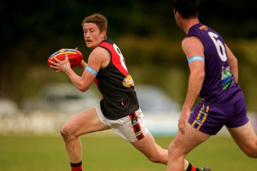 LIGHT ON FEET: Cobden's Grady Rooke evades a Port Fairy opponent in round 13. Picture: Chris Doheny