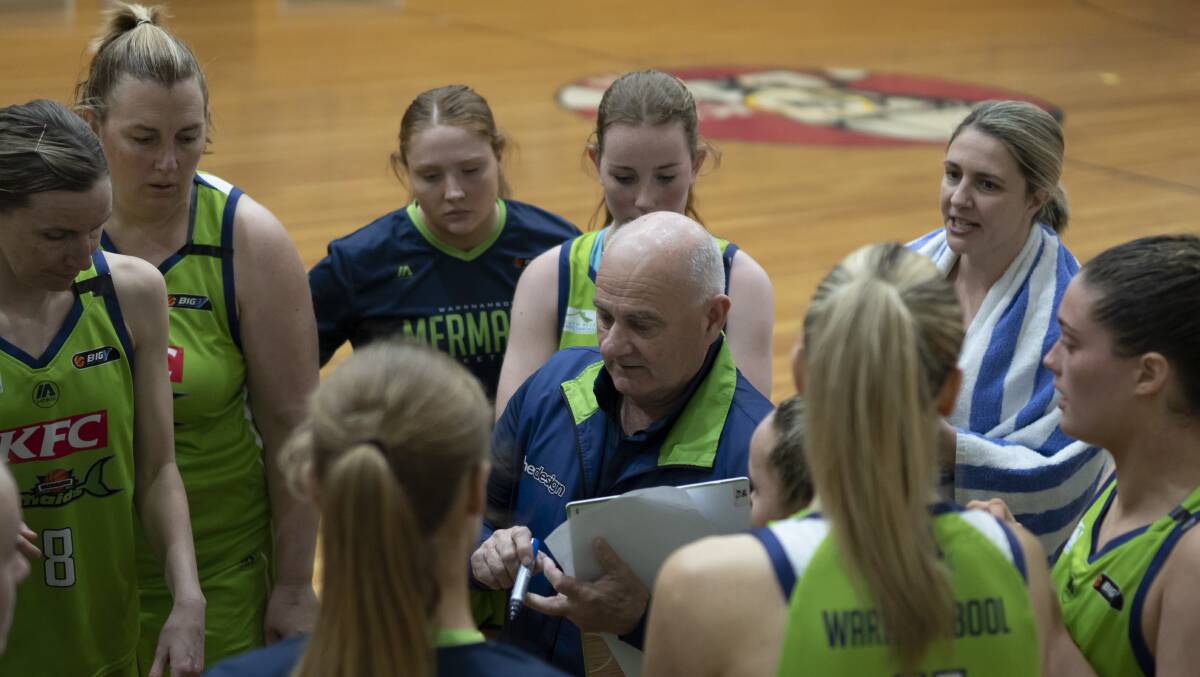EXPERIENCE: Kate Sewell (second from left) listening in on coach Lee Primmer during a break. 