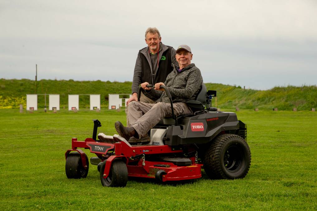 Warrnambool Small Bore Rifle Club secretary Chris Preston and Archers of Warrnambool committee member Jim Burrell with the Warrnambool Sports Target Centre's new commercial-grade mower. Picture: Chris Doheny