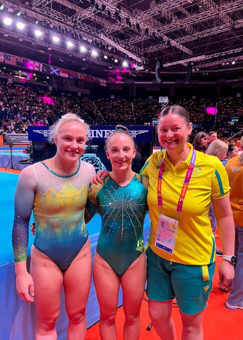 WORLD STAGE: Jessica Mason (right) with Waverley Gymnastic Club athletes, Emily Whitehead and Romi Brown on the competition floor in Birmingham.