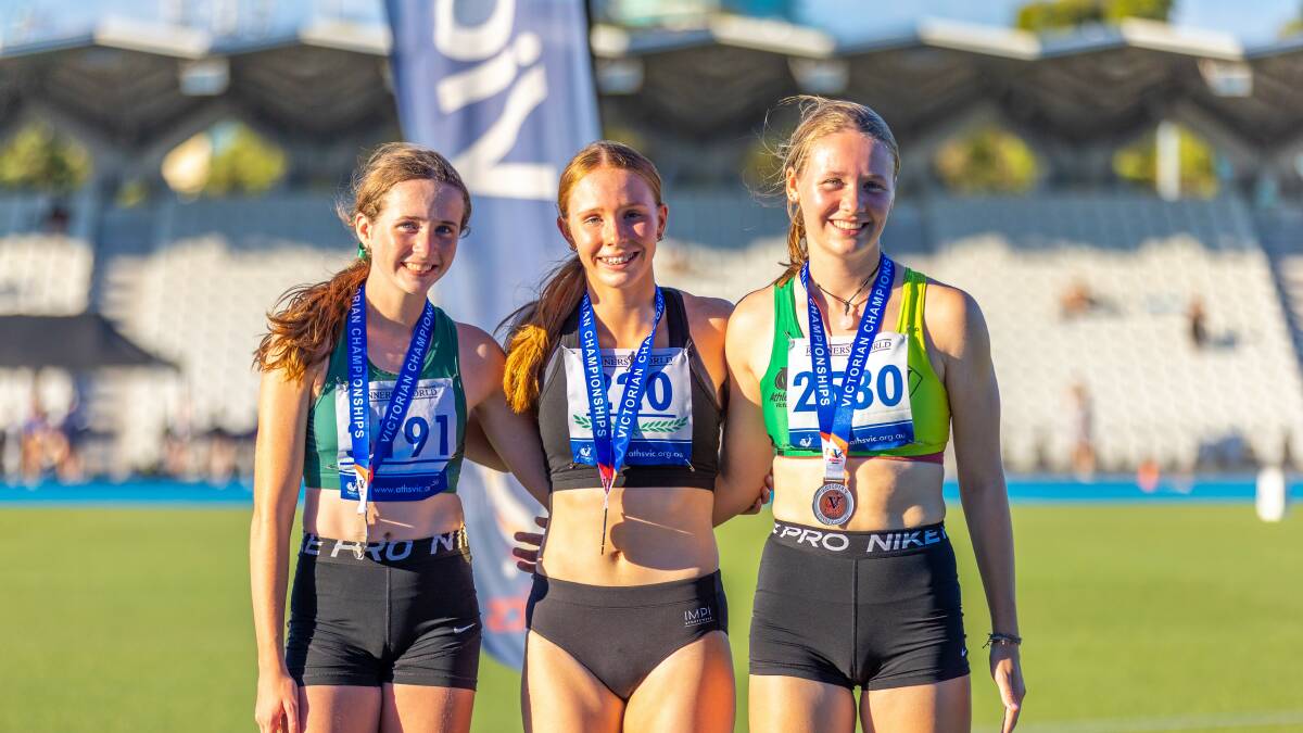 SOAKING IT IN: Grace Kelly (middle) receives her 200m gold medal alongside silver and bronze medallists, Ida Laherty (left) and Katie Oliver (right). Picture: Ryk Neethling