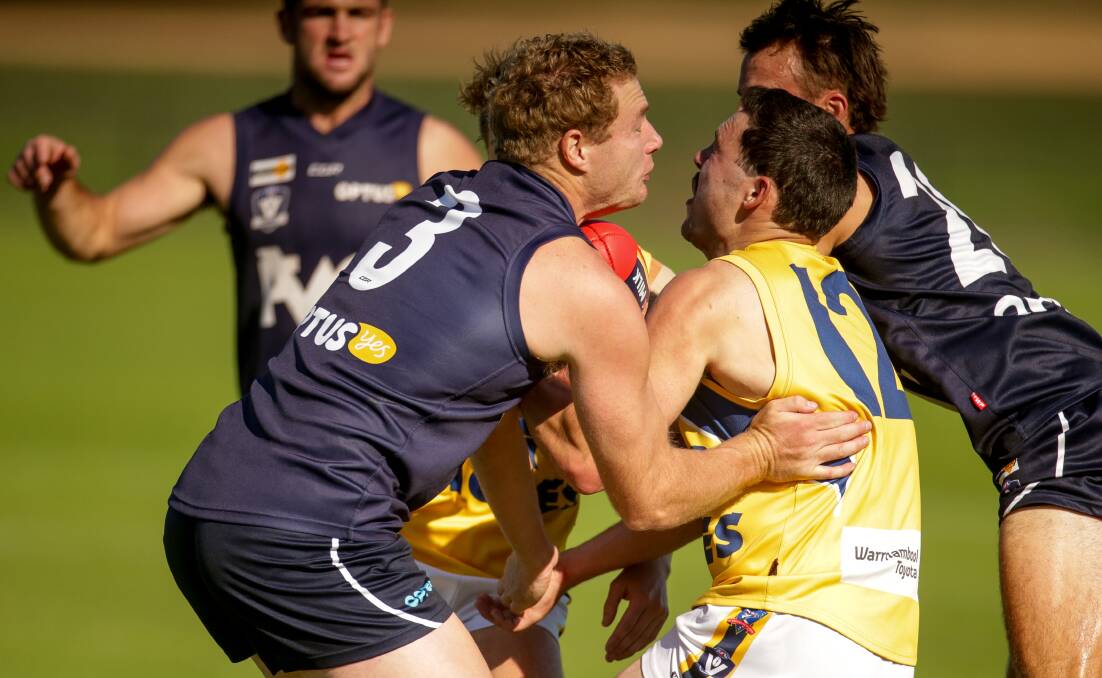 FORCEFUL: Warrnambool's James Chittick crunches Jackson Grundy of North in a tackle. Picture: Chris Doheny