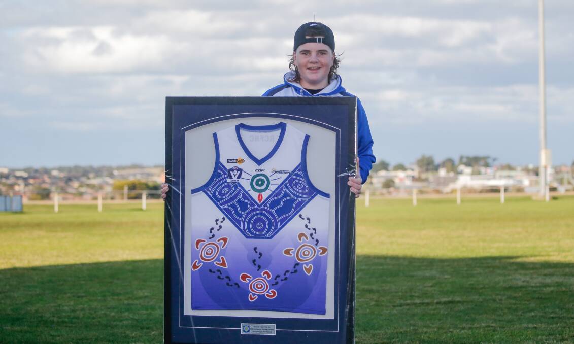 HONOURED: Kobi Chatfield, 13, with a framed Russells Creek's Indigenous guernsey he designed. Picture: Anthony Brady