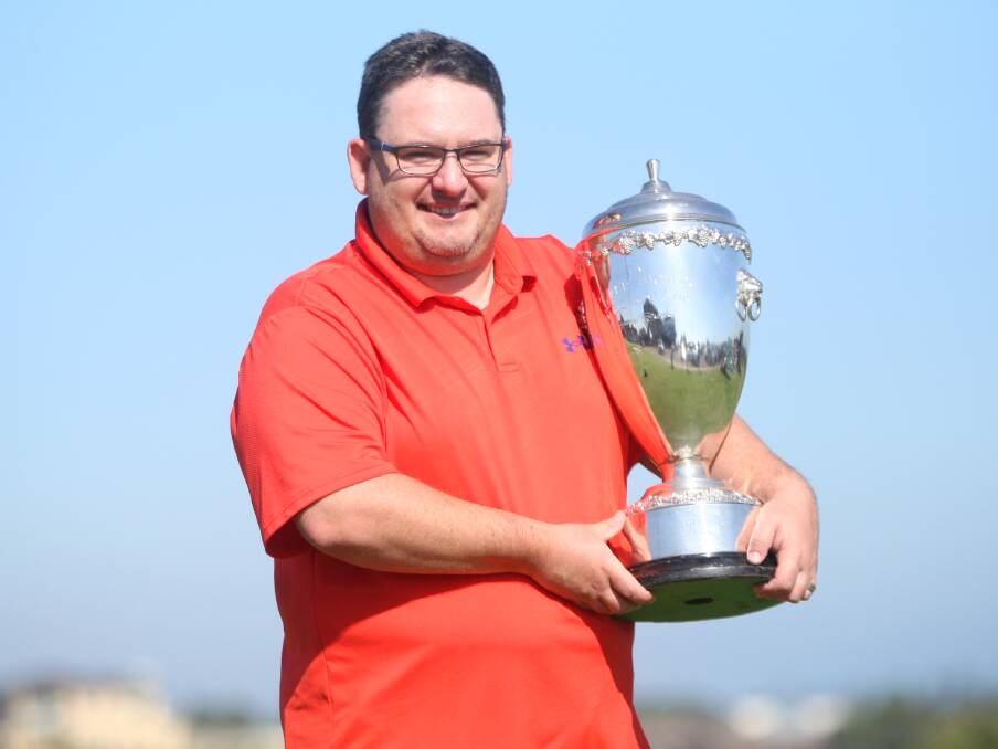 Warrnambool's Daniel Bonham hoists up the Peter Thomson Cup, which he won on Saturday. Picture by Meg Saultry