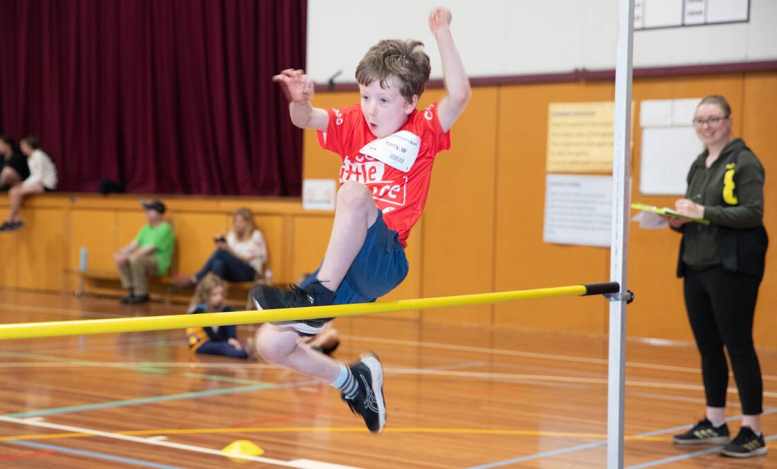 Harry Walz flies over the high jump during Friday's Little Athletics session. Picture by Sean McKenna