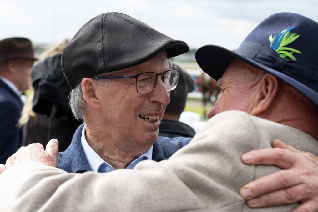 Warrnambool hobby trainer Noel Kelson hugs friend Colin McKenna after Lucas the Younger's win at Warrnambool on Thursday. Picture by Sean McKenna