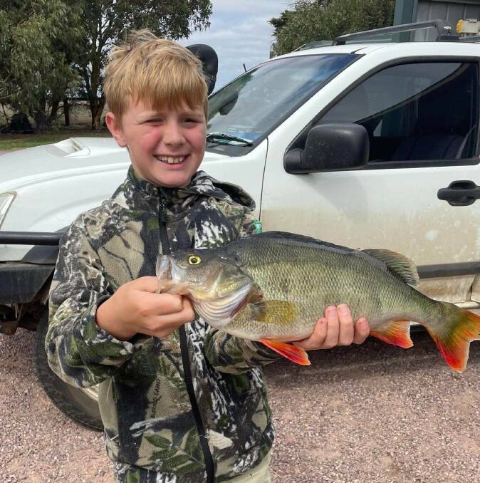 Codi Symons shows off his big redfin caught off Lake Gillear.