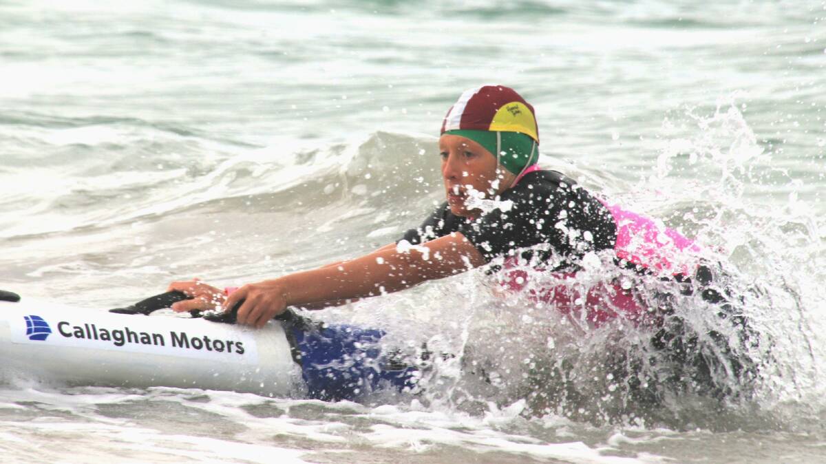 Hugh Fawcett works his way through Lady Bay Beach's waves with his board. Picture supplied/George El-Hage