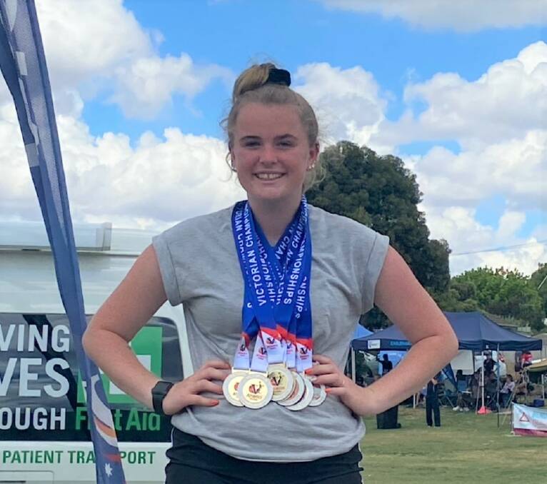 GOLD STANDARD: Warrnambool-based Caytlyn Sharp sporting her seven Victorian Country Track and Field Championship medals, which includes six gold.