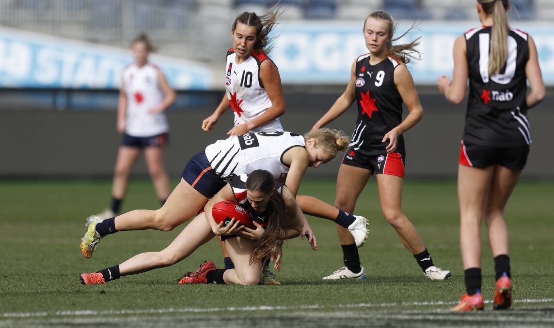 WORKING HARD: Hamilton's Jessica Rentsch (pictured with ball) gets in and under for team black at GMHBA Stadium on Sunday. Picture: Mike Owen/AFL Photos