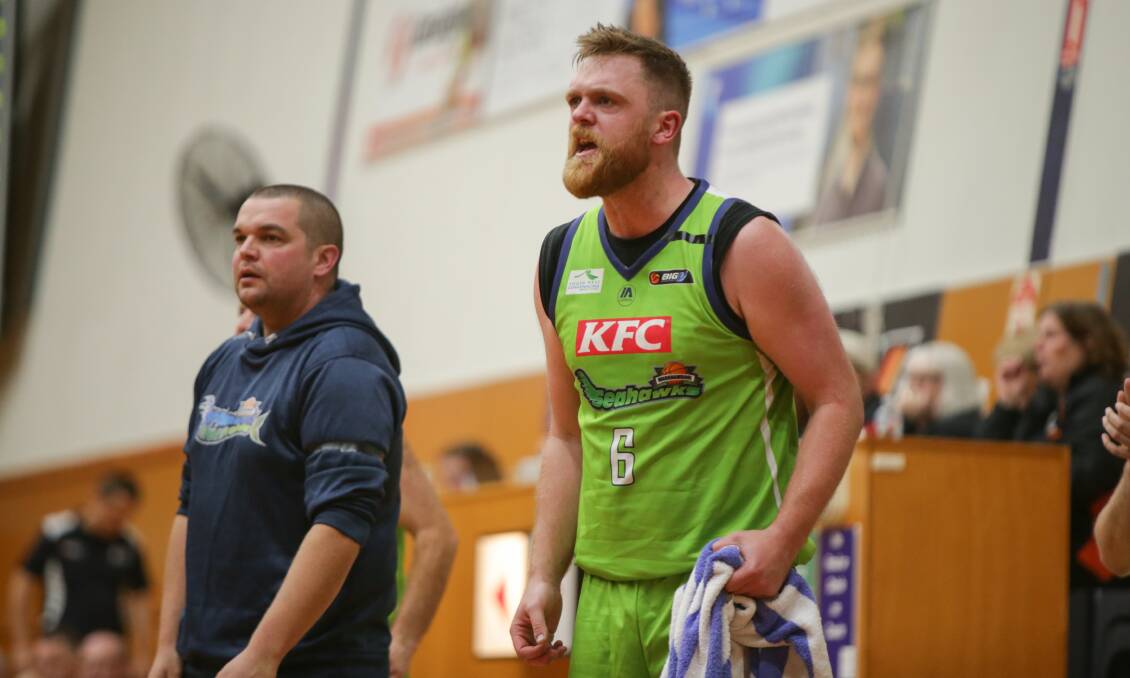 UP AND ABOUT: Jon Carroll and Sam Byron look on from the sidelines in Saturday night's win against Coburg. Picture: Chris Doheny