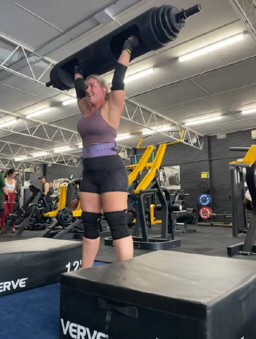 LIz Aitkens, pictured completing a 72.5kg log press, will compete at Australia's Strongest International Showdown on Friday. 
