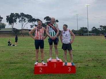 Warrnambool's Carl McMeel (middle) won the masters 800-metre sash at the Essendon Gift.