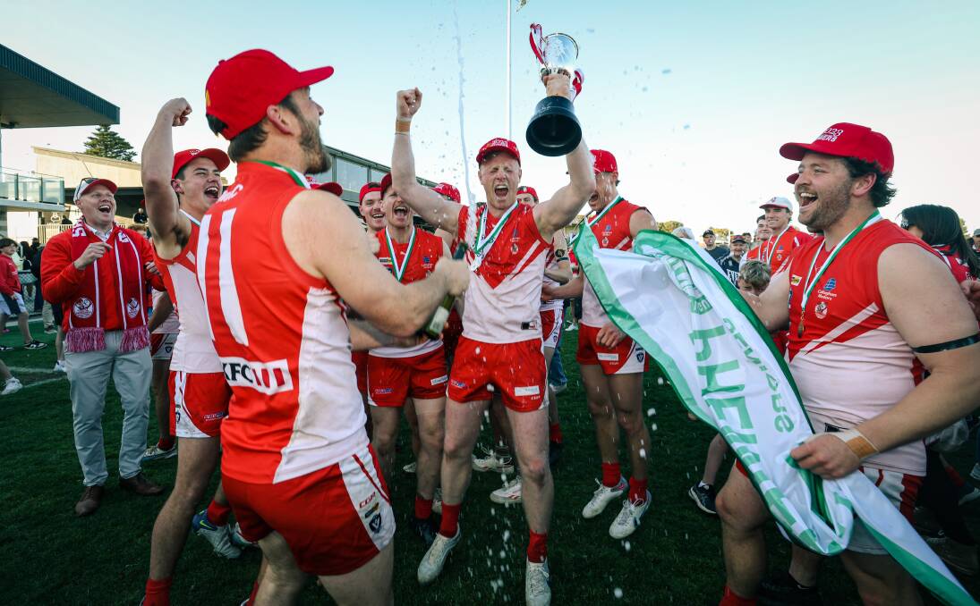 South Warrnambool co-captain Harry Lee, who was one of two best-on-ground medallists, lifts the cup with his teammates. Picture by Sean McKenna