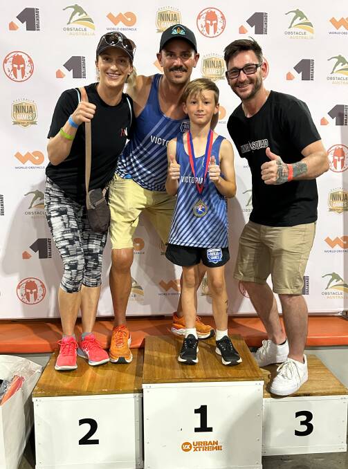Emily, Mark and Lenny Jansz, with coach Matt Murray following Lenny's national championship victory in Brisbane. Picture supplied