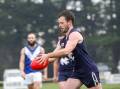 WEATHERING THE STORM: Nirranda's Danny Craven moves the football forward on Saturday as rain falls. Picture: Anthony Brady