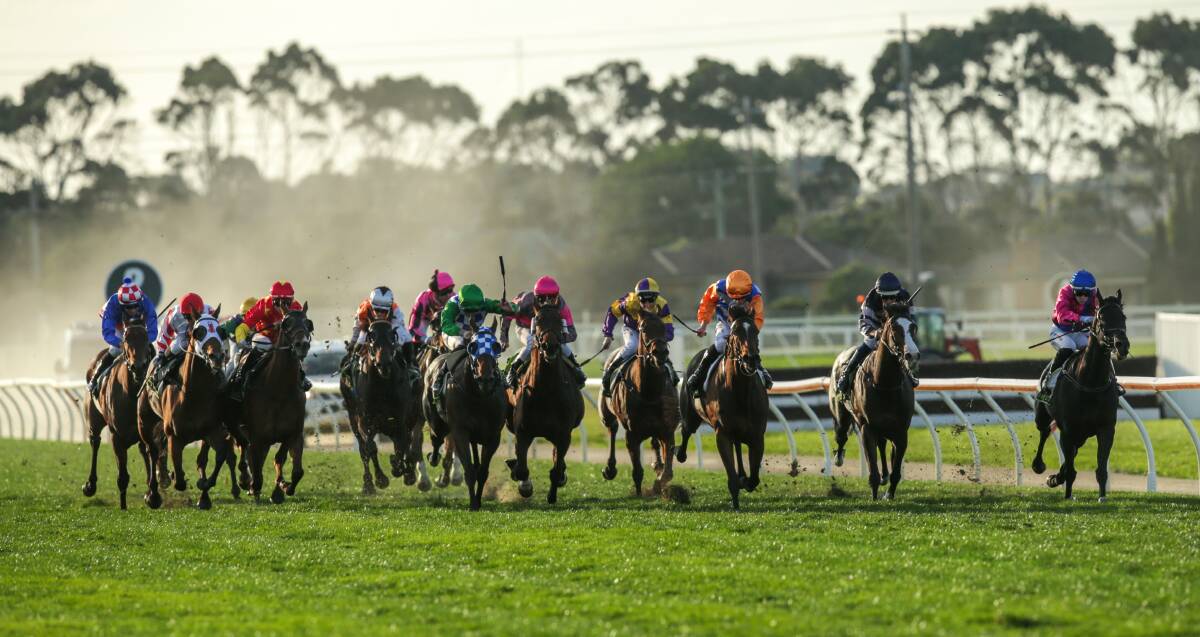 FINAL PUSH: Jockey Jamie Kah (fourth from left, red and yellow colours) finds a gap for Rights of Man on the final straight of the BM64 handicap over 1100m. Picture: Chris Doheny