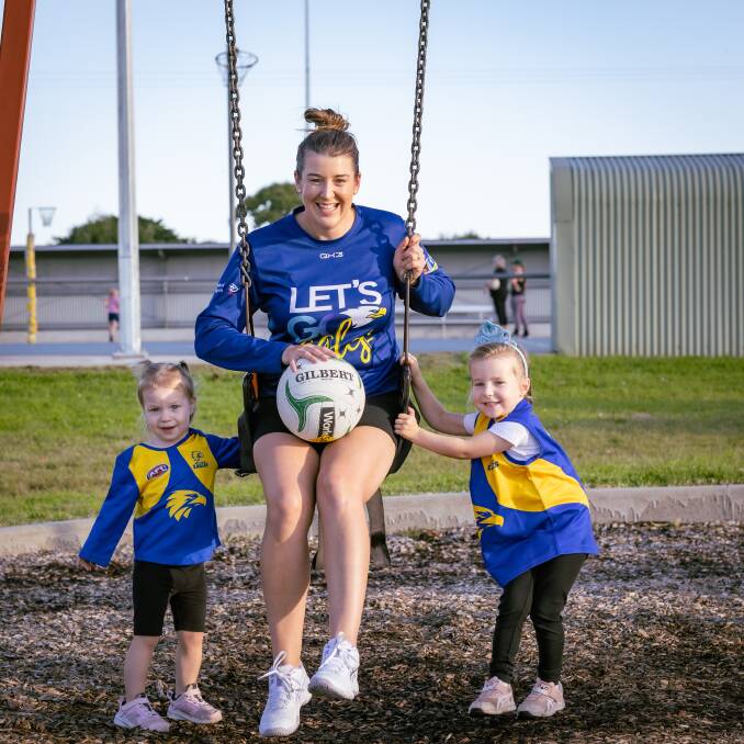 North Warrnambool Eagles' Kim Wines, pictured with daughters Amelia 2 and Isla 4, ahead of her 250th senior game of netball on Saturday. Picture by Sean McKenna