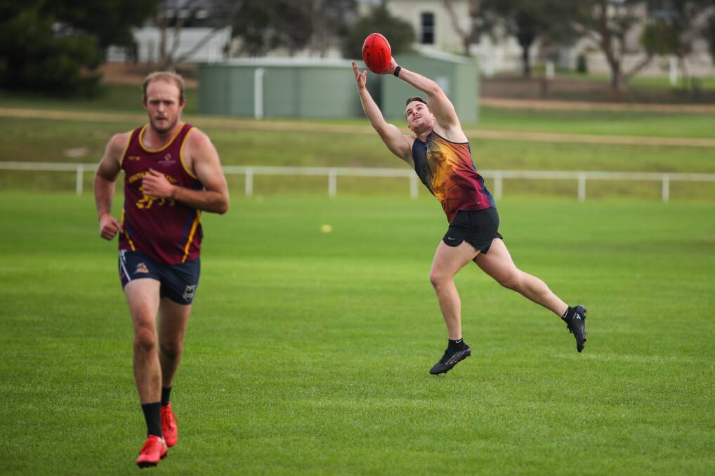 HITTING THE TRACK: Justin Fedley takes a mark at South Rovers training at Walter Oval on Tuesday night. Picture: Morgan Hancock