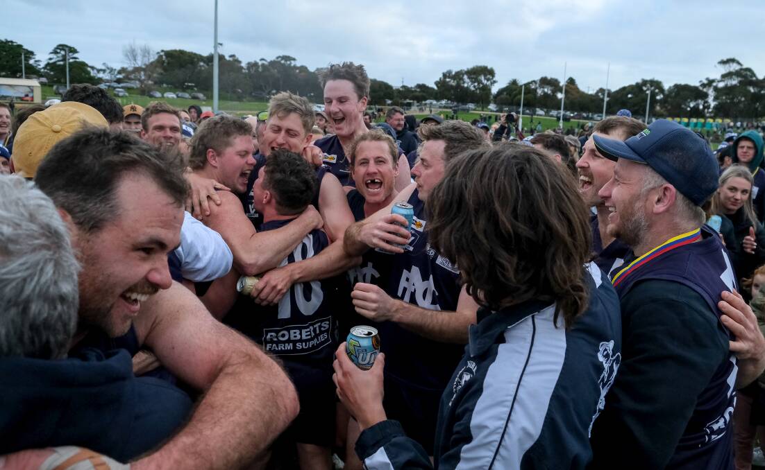 Reagan Nutting and his teammates embrace on the ground after winning the WDFNL grand final at Reid Oval on Saturday. Picture by Chris Doheny