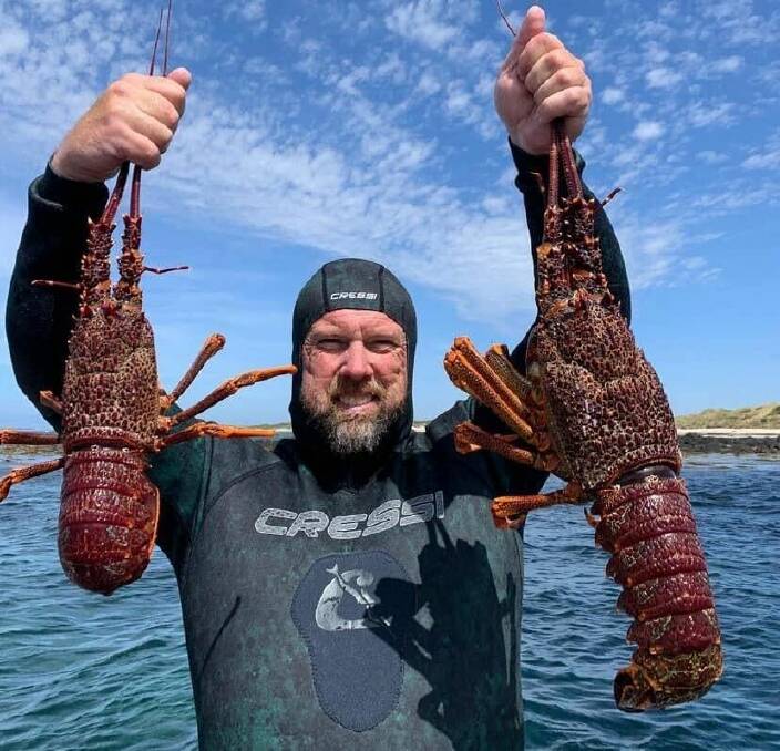 Scott Gray with a handful of crayfish.