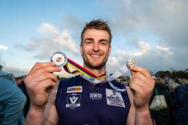Nirranda's John Paulin proudly shows off his premiership and best on ground medals. Picture by Sean McKenna