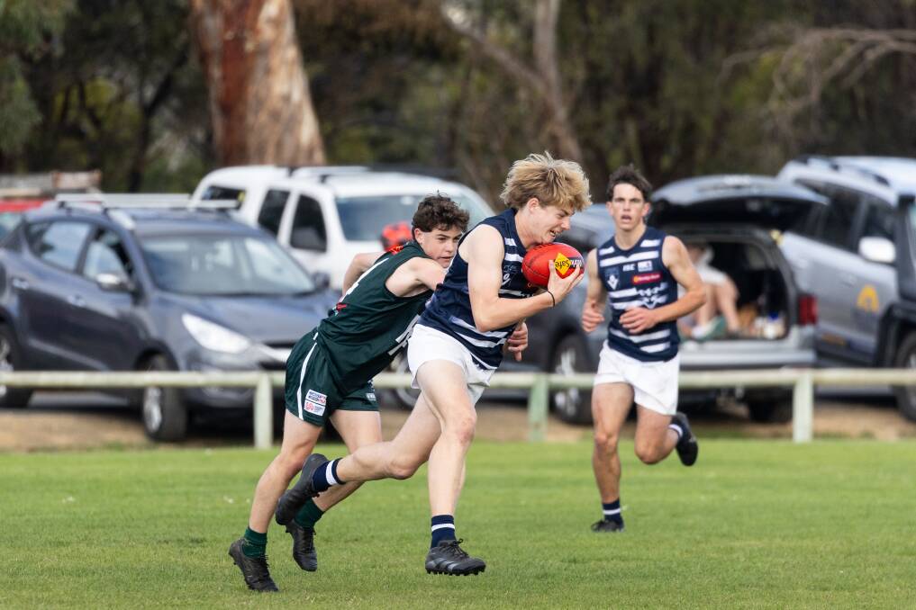 Warrnambool and District league under 17 player Recce Neal holds onto the mark against Hampden East.